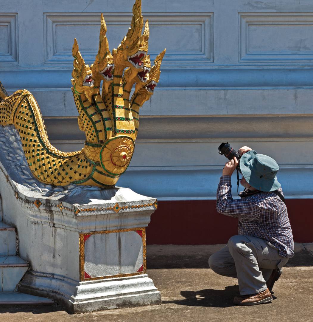 Photographer capturing the History and art at a temple in Luang Prabang |  <i>Peter Walton</i>