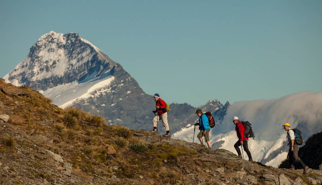 Trekkers on Buchanan peak with Mount Aspiring behind, walking above Matukituki valley, near Lake Wanaka | <i>Colin Monteath</i>