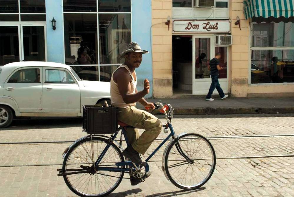 Local Cuban man riding his bike down the street | <i>Vanessa Dean</i>