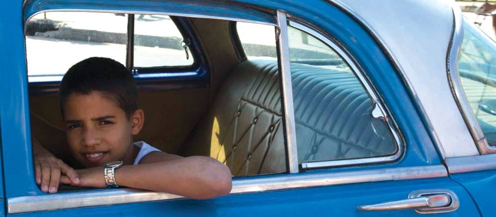 Young boy sitting in a car in Havana | <i>Vanessa Dean</i>