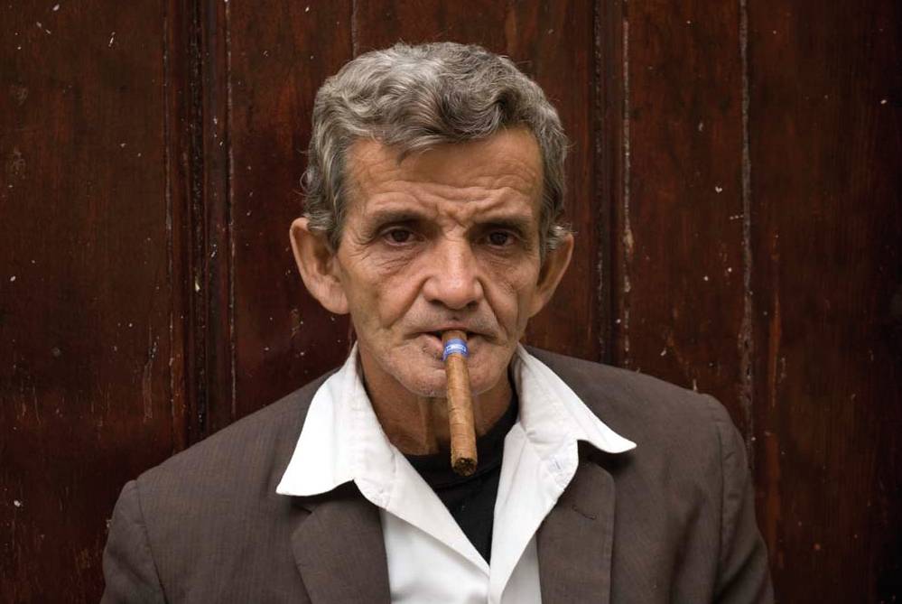 Cuban man enjoying a Cuban cigar | <i>Vanessa Dean</i>