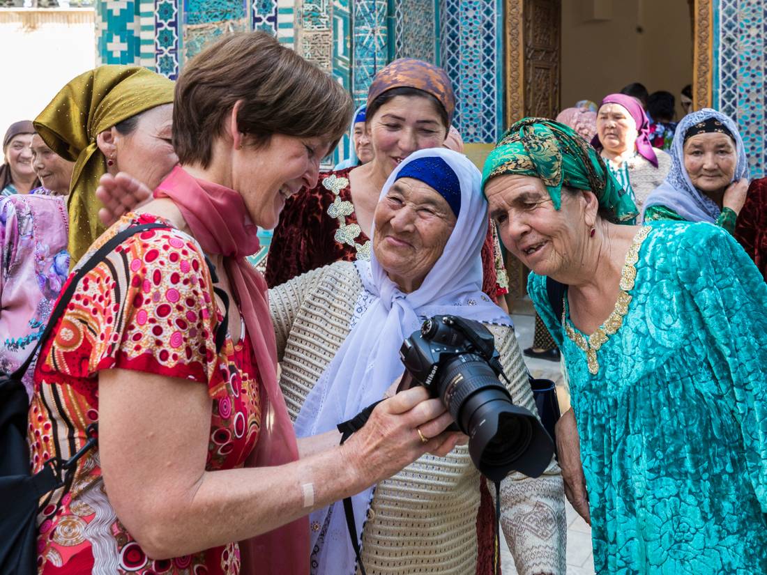 Pilgrims with traveller at Shah-i-Zinda, avenue of mausoleums, Samarkand |  <i>Richard I'Anson</i>