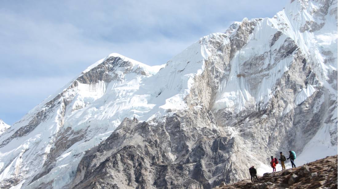 Trekkers dwarfed by the mountains of the Everest Region in Nepal |  <i>Ayla Rowe</i>