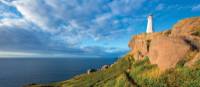 The East Coast Trail skirts the cliffs at Cape Spear Lighthouse | Barrett & MacKay Photo
