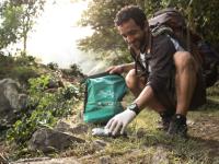 Traveller collecting litter along wilderness trails, part of our 10 Pieces litter collection program -  Photo: Mark Tipple